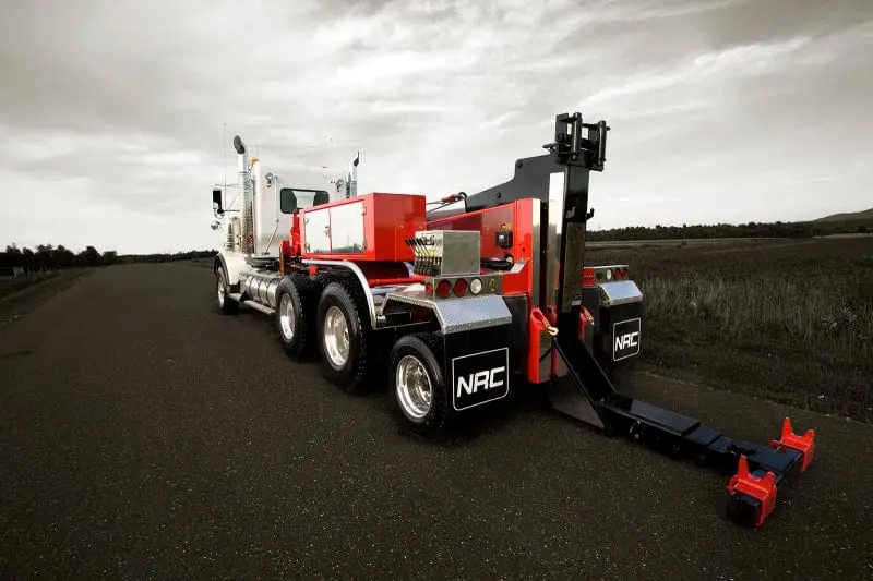 Tow truck parked on empty road.